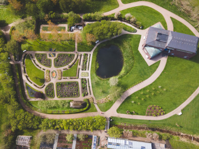 Bird&rsquo;s-eye view of the Nolde House and Nolde Garden in early spring; the beds are still bare, and the winding paths are clearly visible.